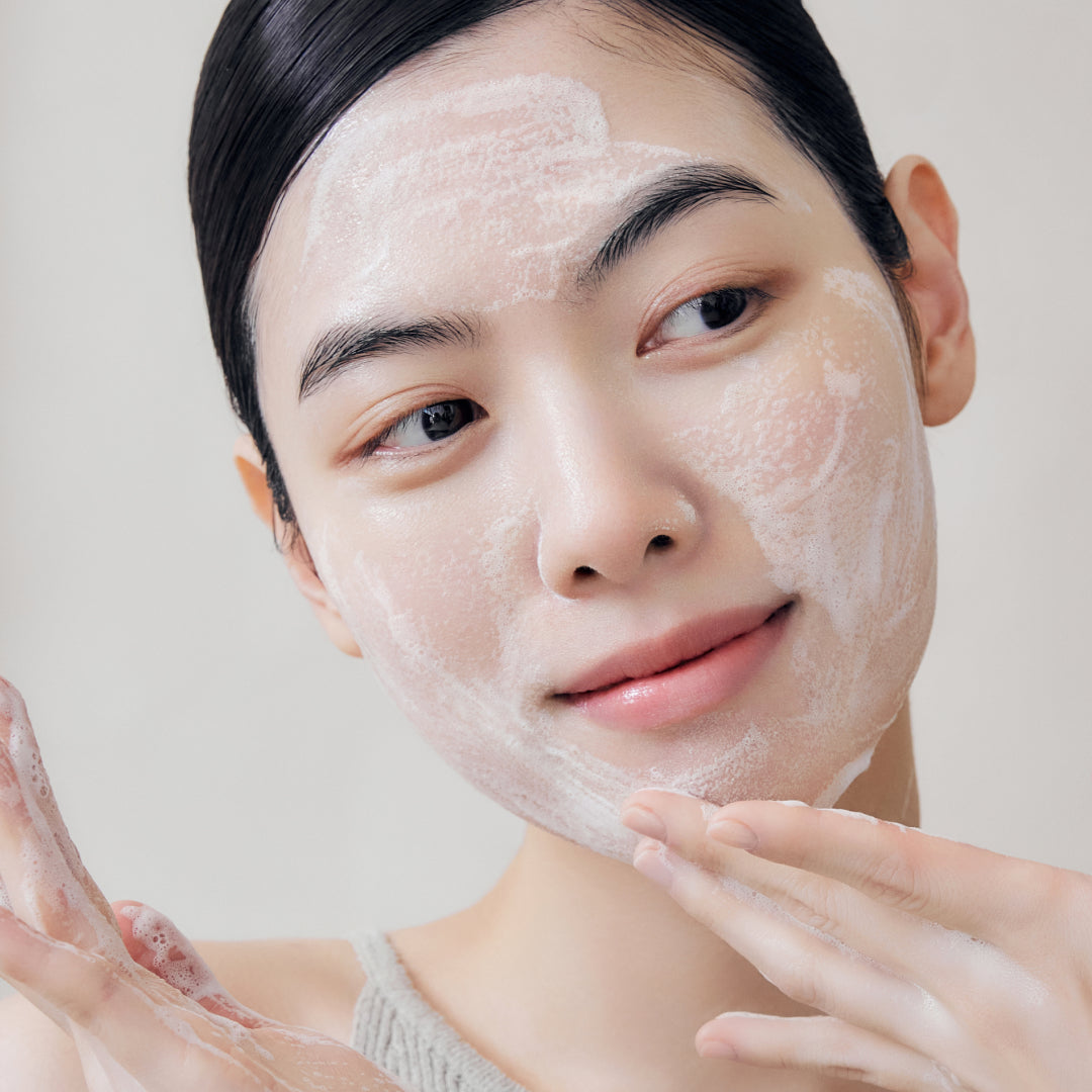 Sulwhasoo The Ultimate S Enriched Cleansing Foam, Korean cleanser, beauty model applying cleanser