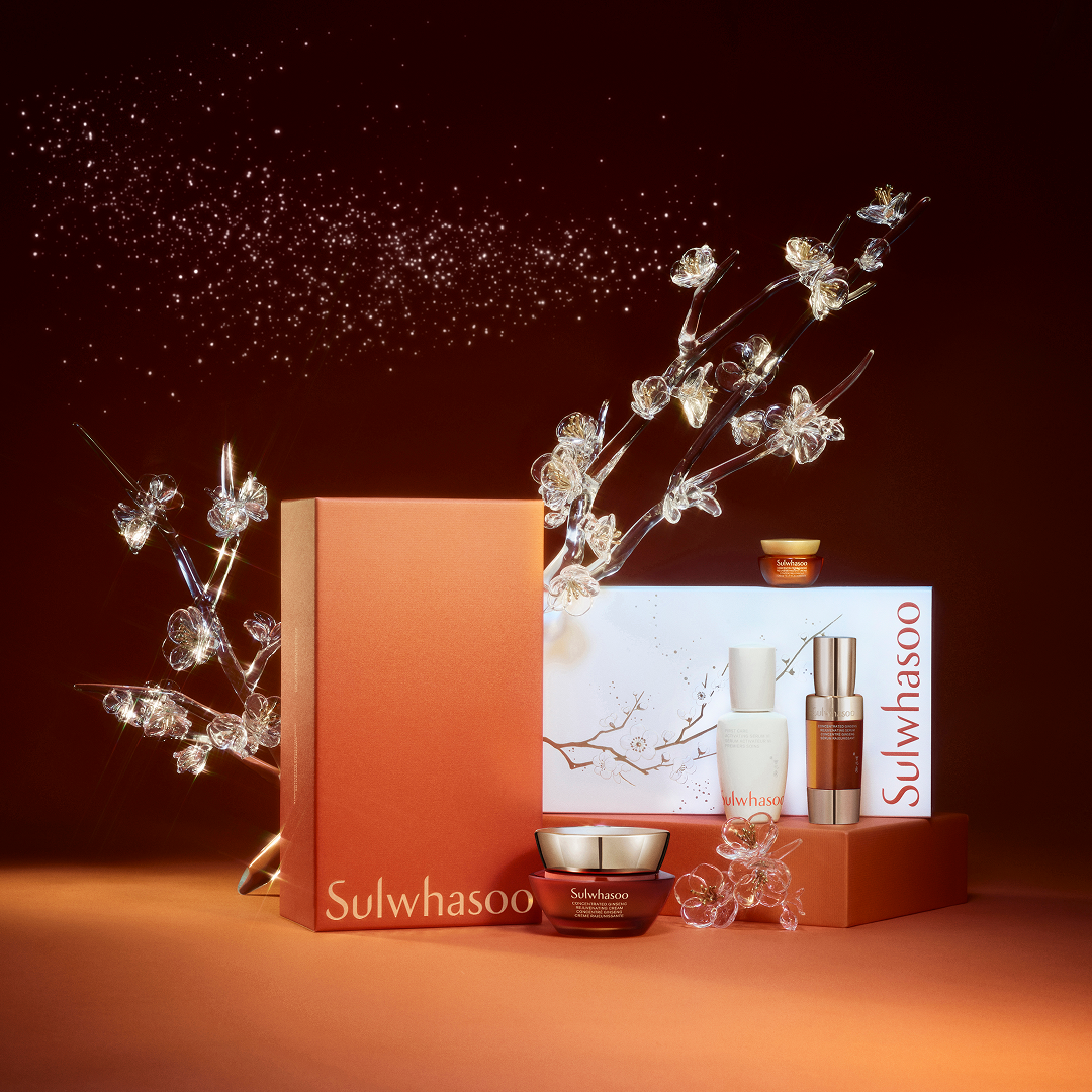 Sulwhasoo skincare products with decorative branches on a dark background