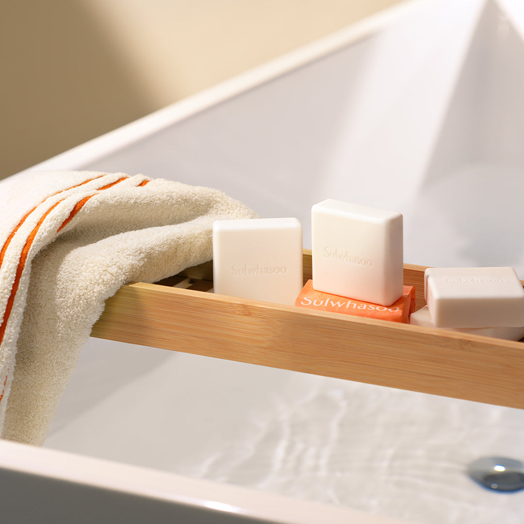Stylized shot of Signature Ginseng Facial Soap in a bathtub