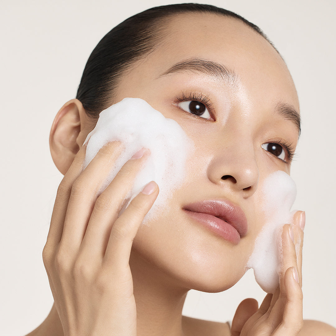 Model with soap foam on face