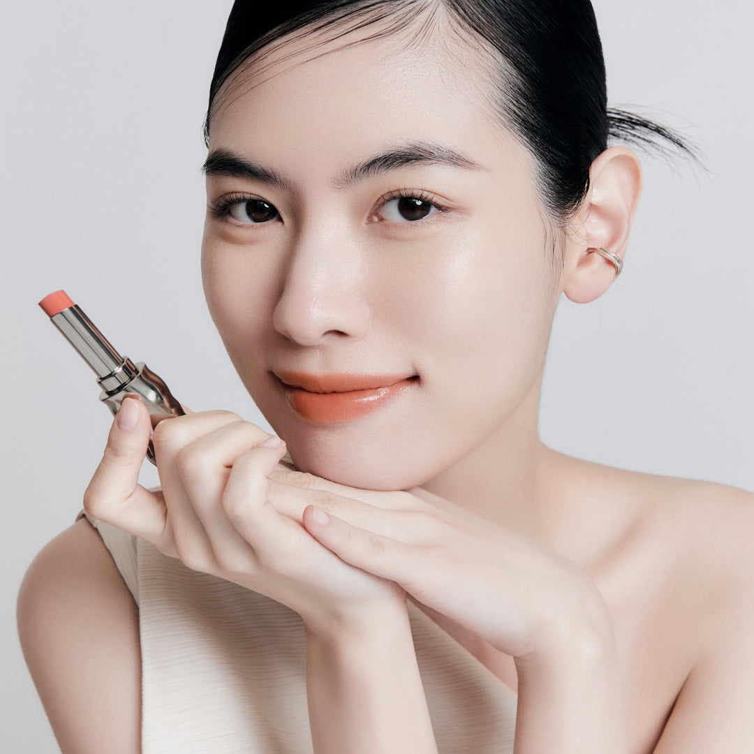 Fair skin beauty model holding and wearing product in shade NO.310 Terra
