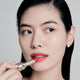 Enlarge image of Fair skin beauty model holding and wearing product in shade NO.460 Berry