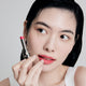 Enlarge image of Fair skin beauty model holding and wearing product in shade NO.999 Rose