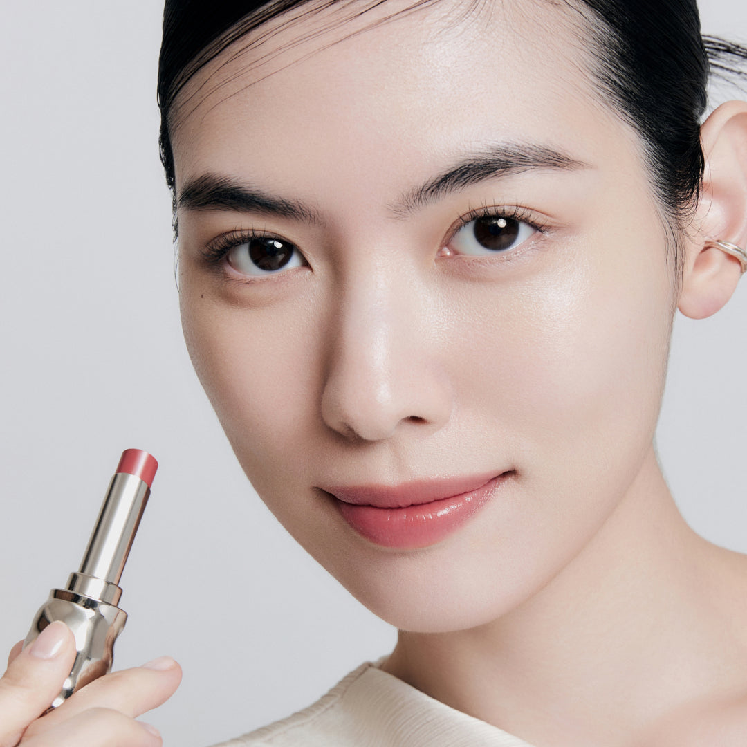 Fair skin beauty model holding and wearing product in shade NO.330 Bloom