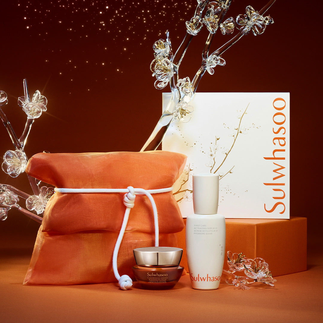 Sulwhasoo skincare products with an orange pouch and decorative elements on a warm-toned background