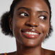 Enlarge image of Dark skin beauty model holding and wearing product in shade NO.520 Amber