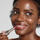 Enlarge image of Dark skin beauty model holding and wearing product in shade NO.460 Berry