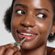 Enlarge image of Dark skin beauty model holding and wearing product in shade NO.370 Peony