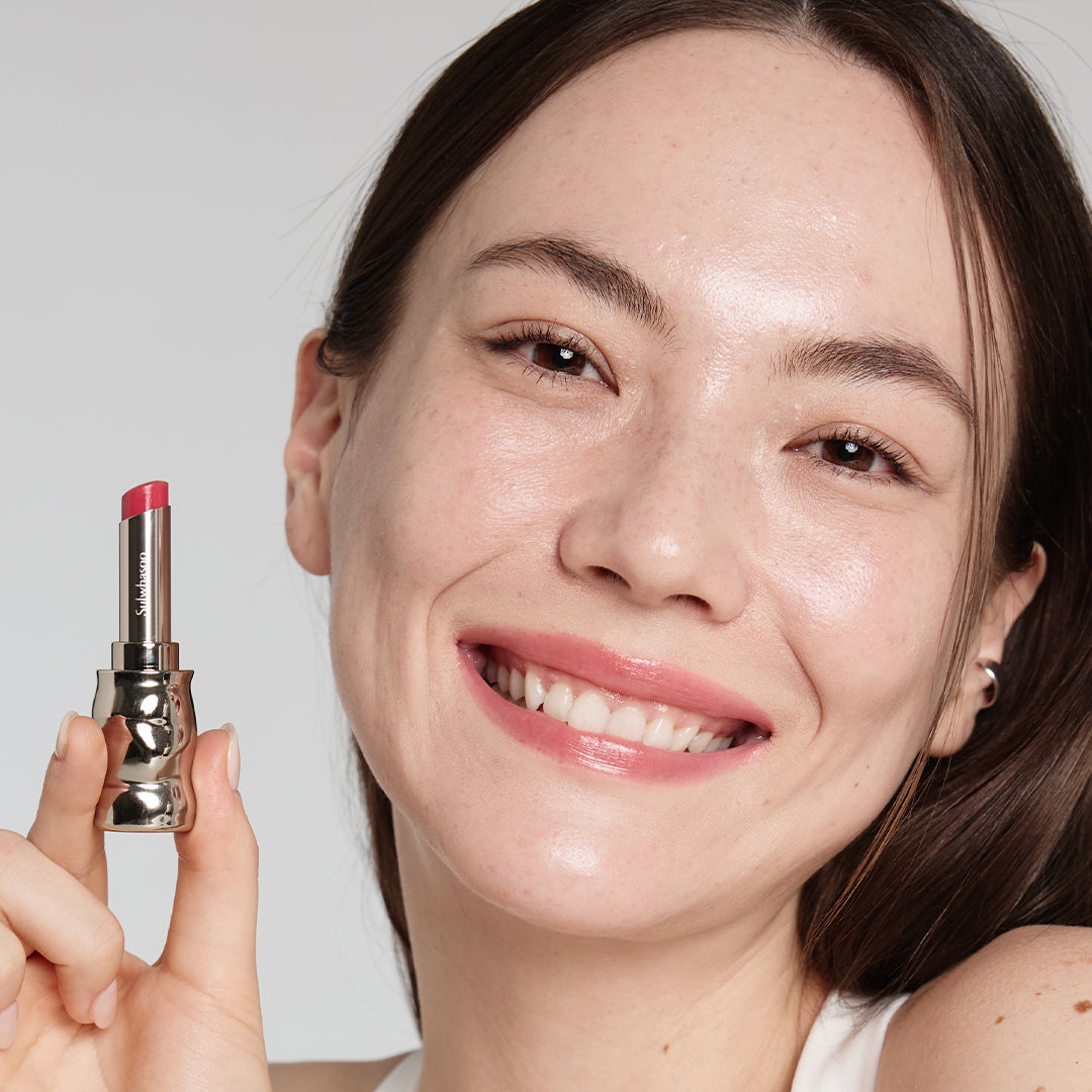 Light skin beauty model holding and wearing product in shade NO.370 Peony