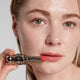 Enlarge image of Light skin beauty model holding and wearing product in shade NO.999 Rose